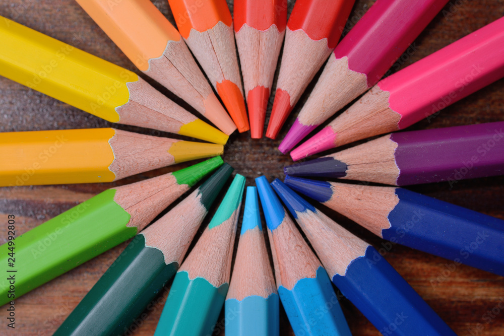 colored wooden pencils located a circle, a close up colored wooden pencils located a circle, a close up