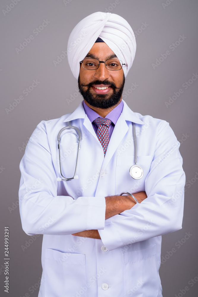 Portrait of young Indian Sikh man doctor smiling Portrait of young Indian Sikh man doctor smiling