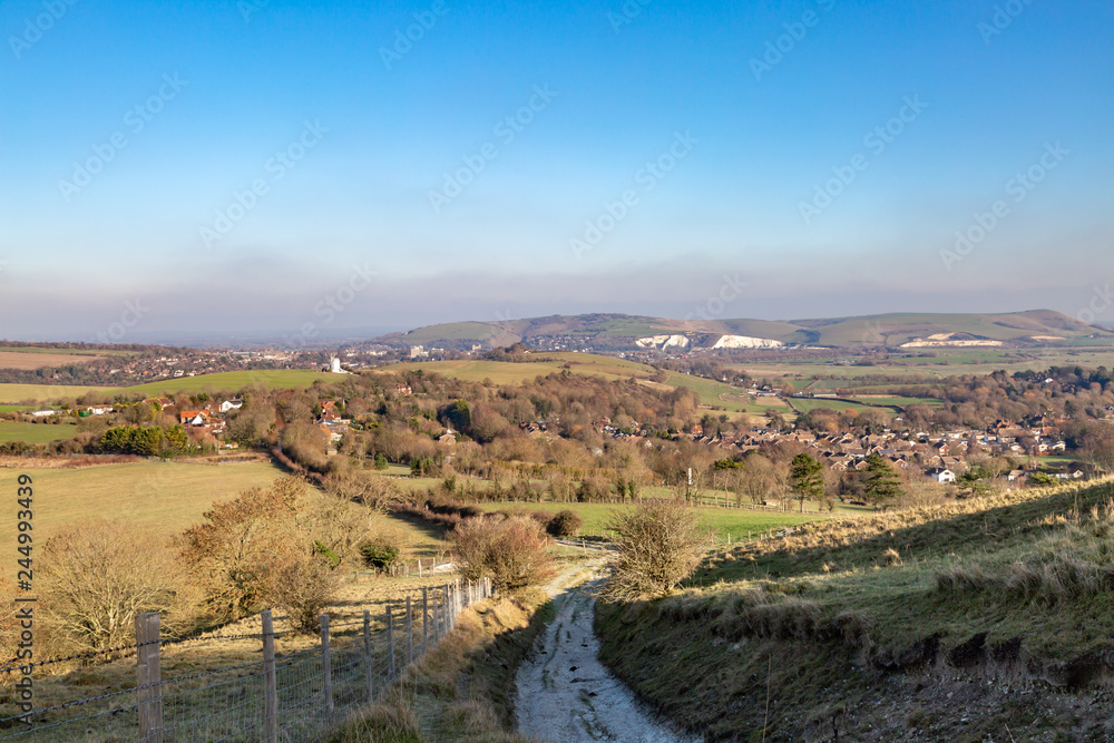 Looking out over Kingston village with Lewes and Mount Caburn beyond, from a pathway in the South Downs