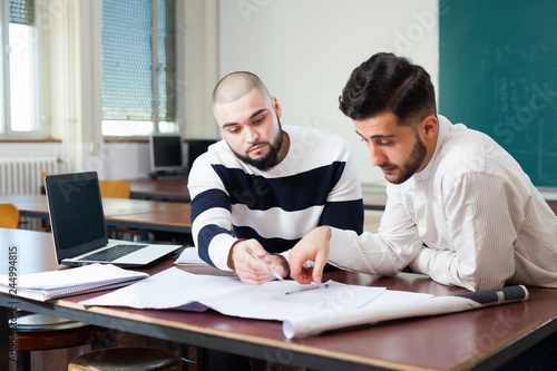 Students working with laptop at desk