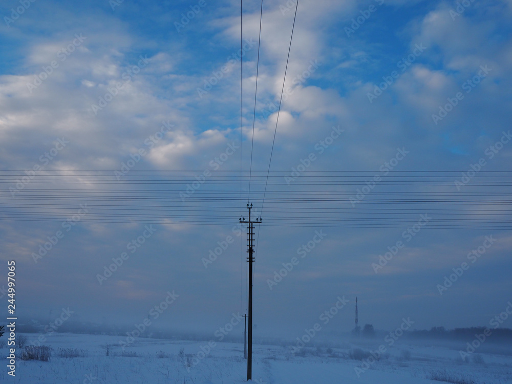 Electric support and crossed wires on blue sky background