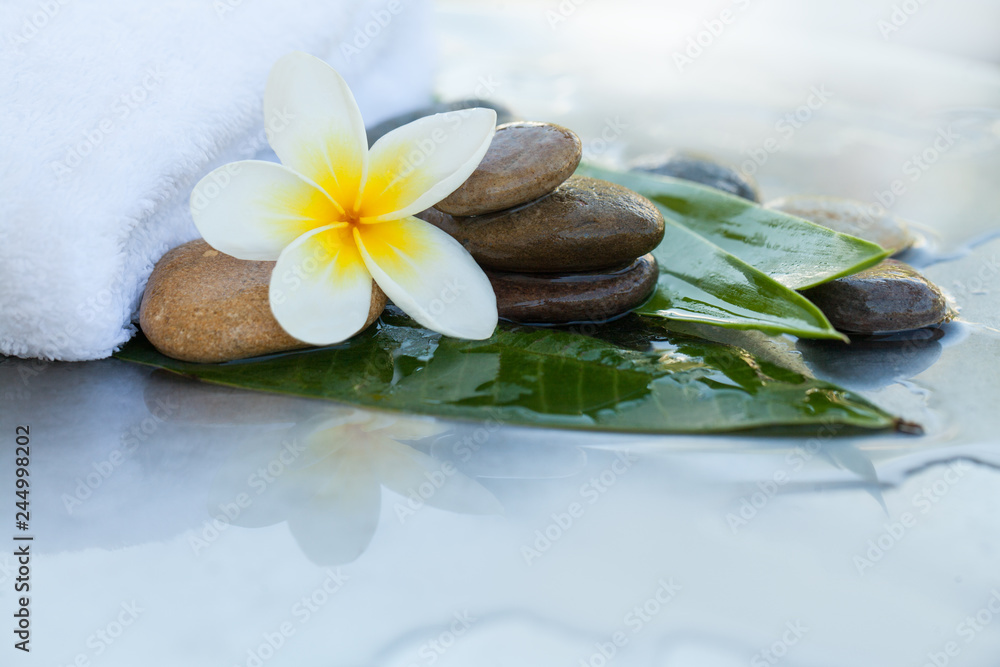 Stones, flower, towel and leaves for massage Stones, flower, towel and leaves for massage