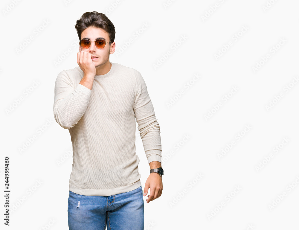 Young handsome man wearing sunglasses over isolated background looking stressed and nervous with hands on mouth biting nails. Anxiety problem. Young handsome man wearing sunglasses over isolated background looking stressed and nervous with hands on mouth biting nails. Anxiety problem.