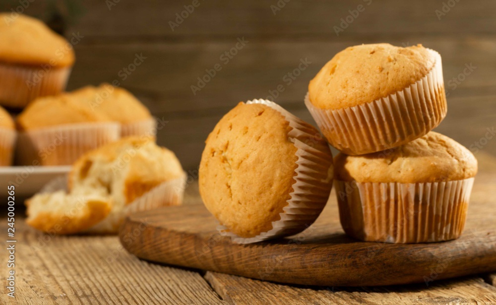 Vanilla cupcake, homemade cakes on wooden background Vanilla cupcake, homemade cakes on wooden background