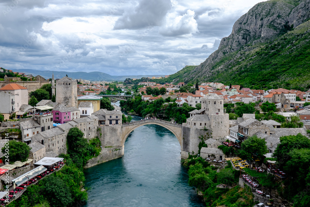Storm clouds gather over the beautiful ancient Stari Most bridge which proudly spans the Neretva river, connecting the two halves of the city of Mostar for centuries.