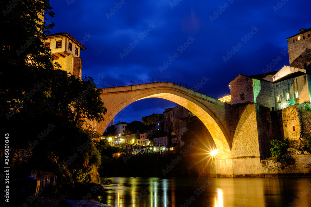 The Stari Most bridge over the river Neretva in Mostar, standing in its full glory against the blue night skies