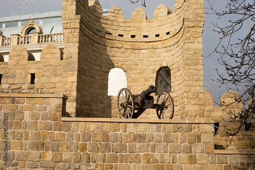 Narrow streets of the old city, ancient buildings and walls. Baku, Azerbaijan anicient cannon photo