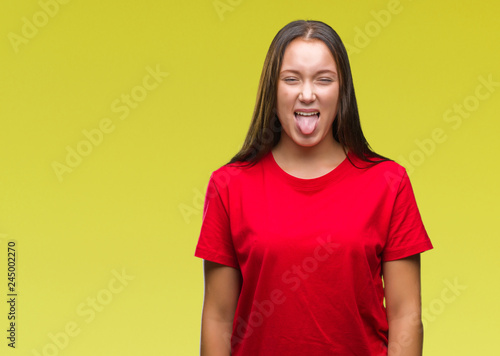 Young beautiful caucasian woman over isolated background sticking tongue out happy with funny expression. Emotion concept.