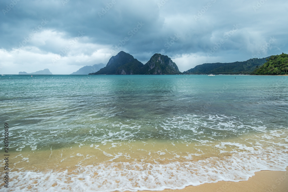 Landscape of Palawan, El Nido. Ocean and rock islands in background. Cloudy stormy sky after taifun. Philippines