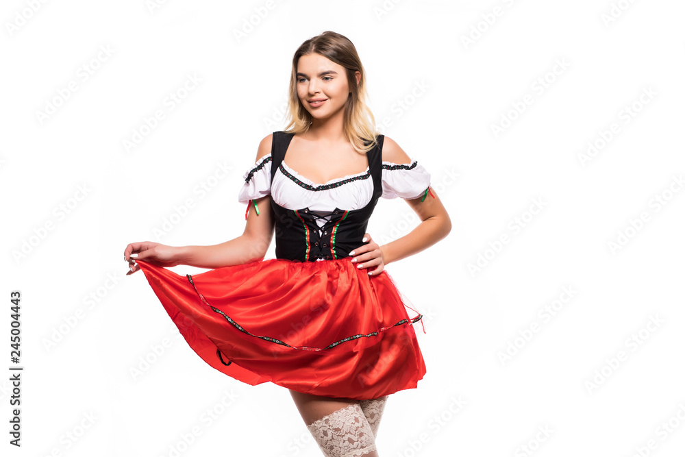 Attractive blonde woman in a traditional red dirndl isolated on white background