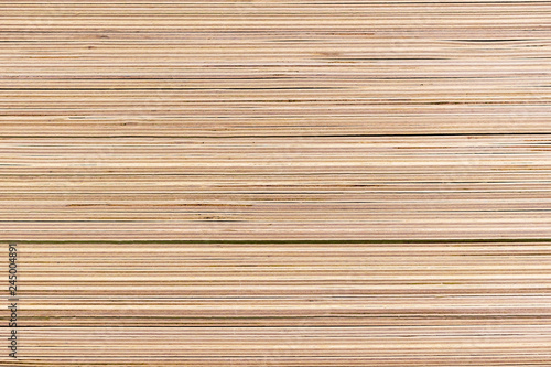 Piled sheets of plywood in a building materials store.