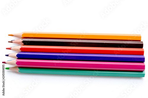 Close up of multicolored crayons on a white background