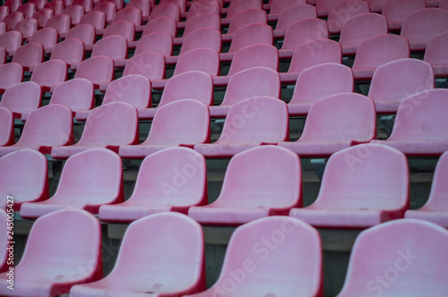 Red seats in the stadium. Empty seat of football stadium