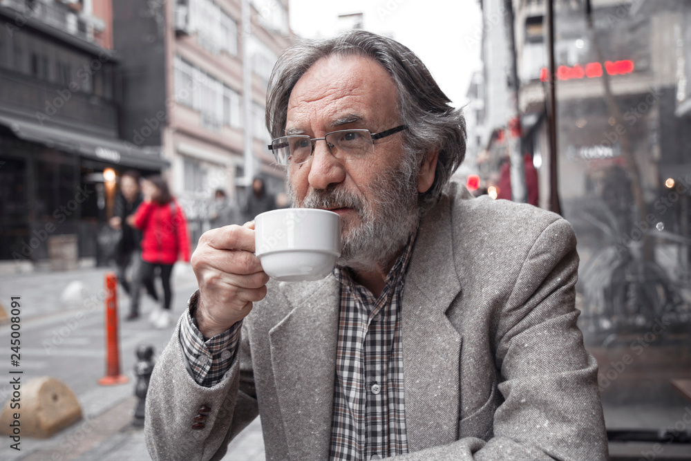 Old man drinking coffee in outdoors Old man drinking coffee in outdoors