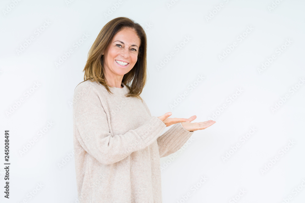 Beautiful middle age woman over isolated background Inviting to enter smiling natural with open hand Beautiful middle age woman over isolated background Inviting to enter smiling natural with open hand