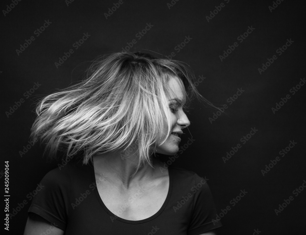 Dramatic black and white portrait of a beautiful woman on a dark background Dramatic black and white portrait of a beautiful woman on a dark background