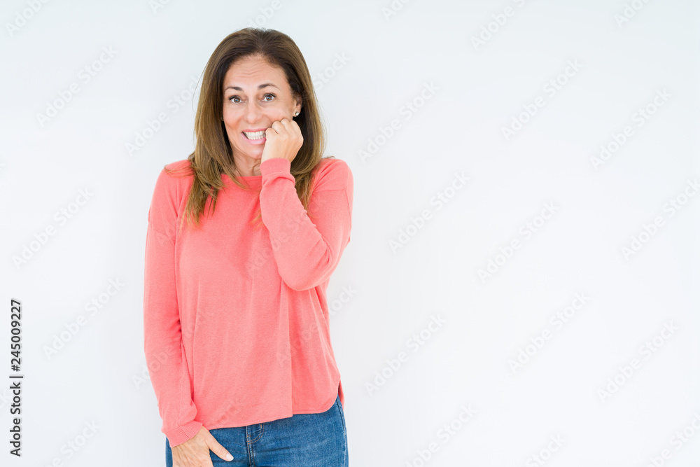 Beautiful middle age woman over isolated background looking stressed and nervous with hands on mouth biting nails. Anxiety problem. Beautiful middle age woman over isolated background looking stressed and nervous with hands on mouth biting nails. Anxiety problem.