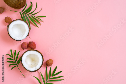 Pink tropical background with coconut and palm leaves