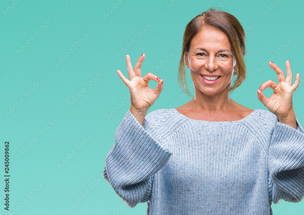 Middle age senior hispanic woman wearing winter sweater over isolated background relax and smiling with eyes closed doing meditation gesture with fingers. Yoga concept. Middle age senior hispanic woman wearing winter sweater over isolated background relax and smiling with eyes closed doing meditation gesture with fingers. Yoga concept.