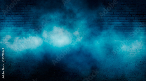 Background of empty dark room with brick walls, illuminated by neon blue lights with laser beams, smoke