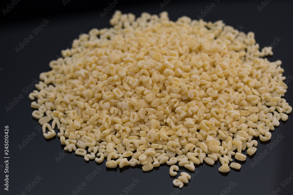 Alphabet pasta on black background Alphabet pasta on black background