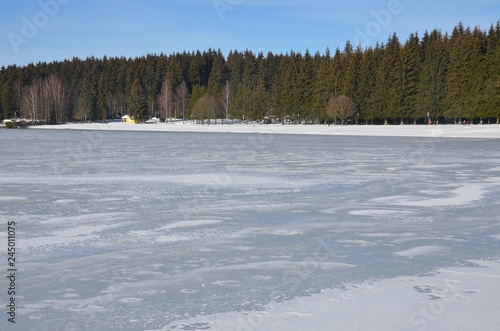 Vereister Stausee am Waldrand - Geyer im erzgebirge photo