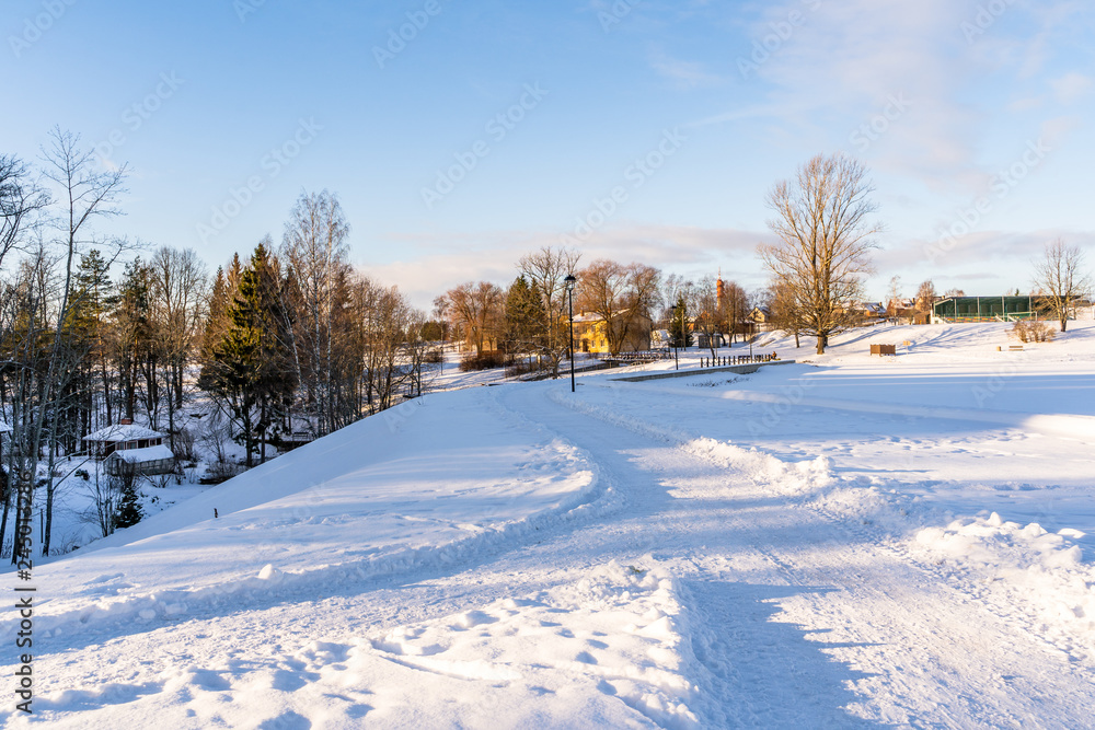 Photo of an Empty Park on Sunny Winter Day with Blue Sky and Clouds in the Background