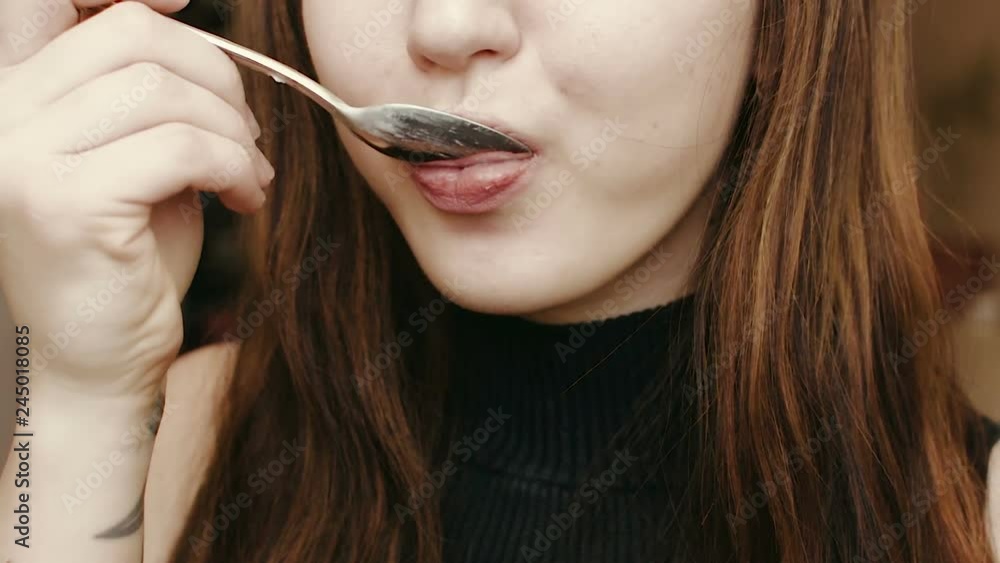 Young girl eats yogurt. Light breakfast. Close-up face. HD Young girl eats yogurt. Light breakfast. Close-up face. HD