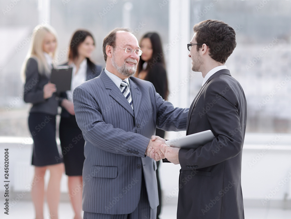 project Manager shaking hands with the employee prior to the seminar project Manager shaking hands with the employee prior to the seminar