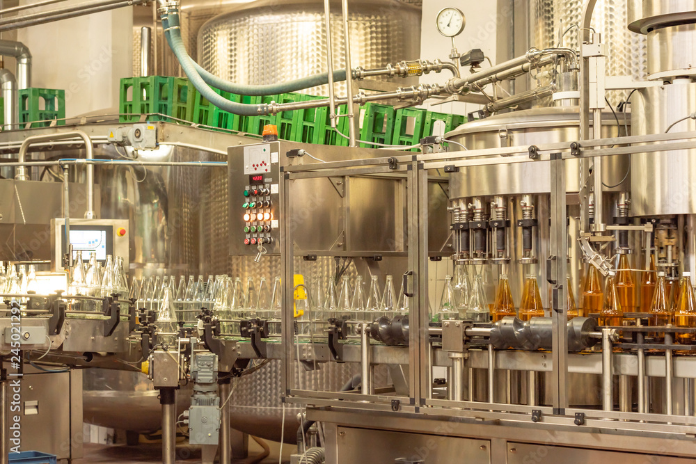 Filling bottles with juice. Bottling of drinks. bottling plant Filling bottles with juice. Bottling of drinks. bottling plant