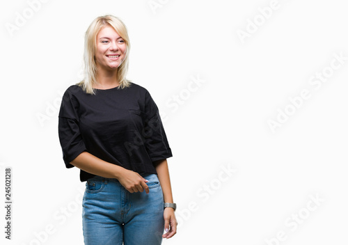Young beautiful blonde woman over isolated background looking away to side with smile on face, natural expression. Laughing confident.