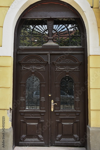 old brown  wooden door with wrought iron  in Bistrita  Romania