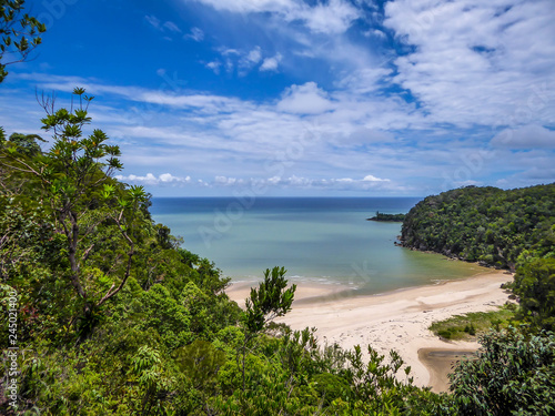 Fototapeta Naklejka Na Ścianę i Meble -  A hidden beach in Borneo, Bako National Park, Malaysia. Seen from a high situated viewing point. Hidden paradise. Beautiful destination for holidays. Beach surrounded by forest and cliffs.