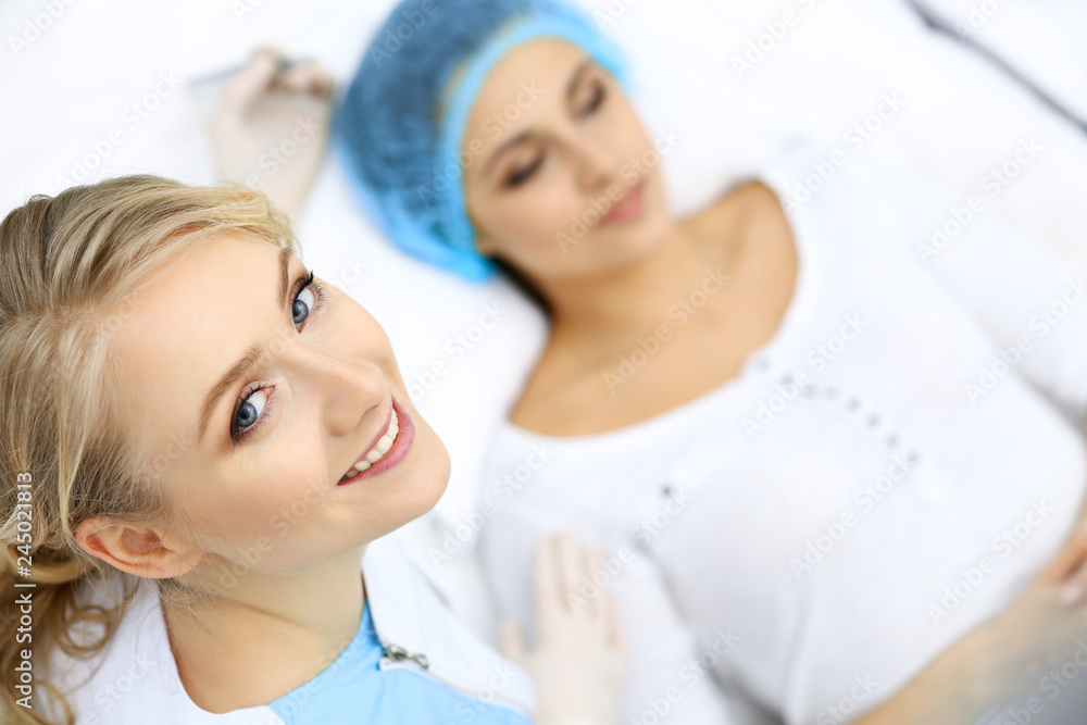 Professional beautician doing eyebrow tattoo at woman face. Permanent brow makeup in beauty salon, closeup. Cosmetology treatment Professional beautician doing eyebrow tattoo at woman face. Permanent brow makeup in beauty salon, closeup. Cosmetology treatment