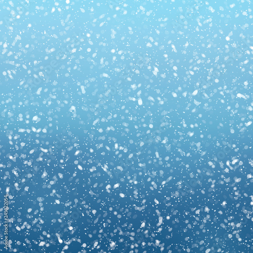 Snow falls on winter blue sky background