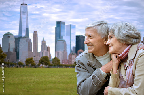 Canvas Print happy senior couple posing on green meadow against