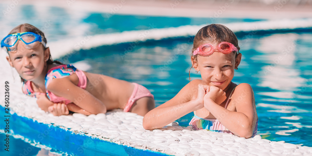 Adorable little girls in outdoor swimming pool Adorable little girls in outdoor swimming pool
