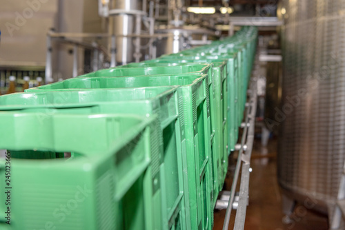 Crates are transported to conveyor belt and moved to the filling line.