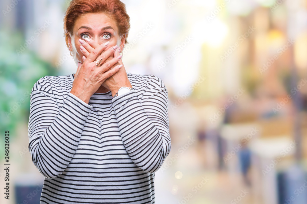 Atrractive senior caucasian redhead woman over isolated background shocked covering mouth with hands for mistake. Secret concept. Atrractive senior caucasian redhead woman over isolated background shocked covering mouth with hands for mistake. Secret concept.