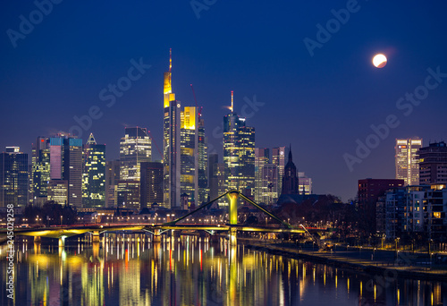 End of the lunar eclipse over the skyline of Frankfurt  Germany.