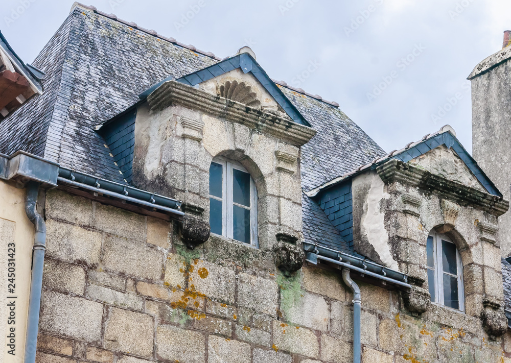 The facade of a private half-timbered house in Quimperle (France)