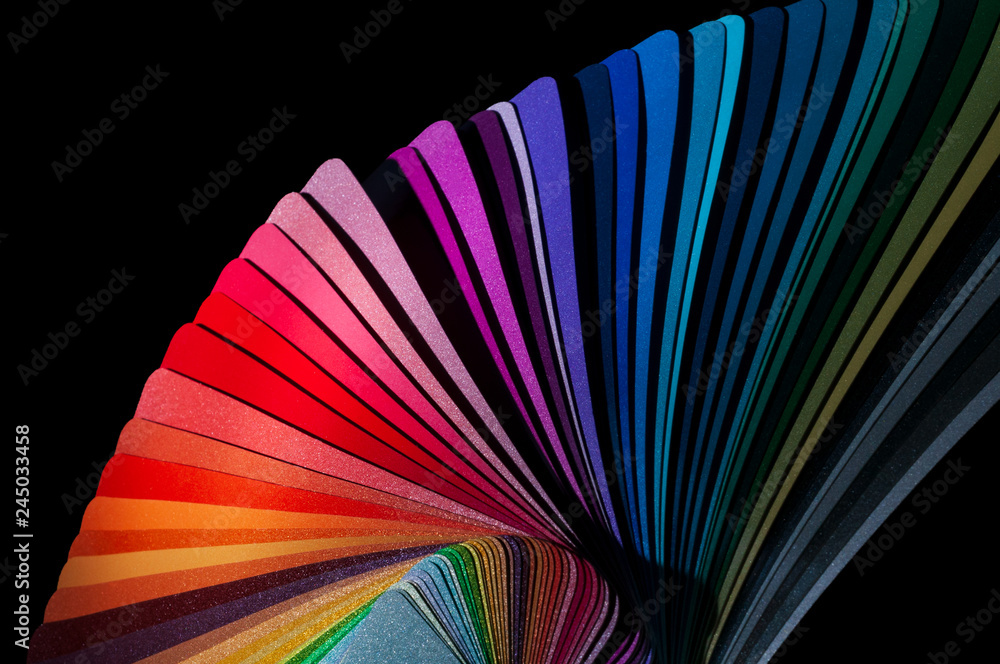 Color fan deck with samples of various paint isolated on a black