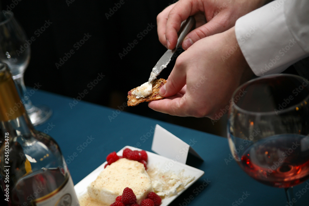 spreading cheese on a cracker spreading cheese on a cracker
