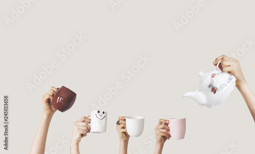 Hands holding different cup on isolated background