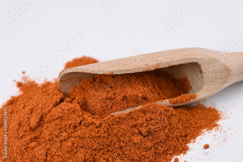 Wooden scoop of paprika powder