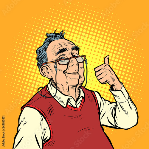 joyful elderly man with glasses thumb up like