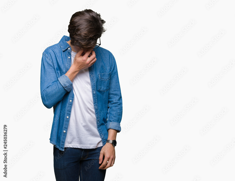 Young handsome man wearing glasses over isolated background tired rubbing nose and eyes feeling fatigue and headache. Stress and frustration concept. Young handsome man wearing glasses over isolated background tired rubbing nose and eyes feeling fatigue and headache. Stress and frustration concept.