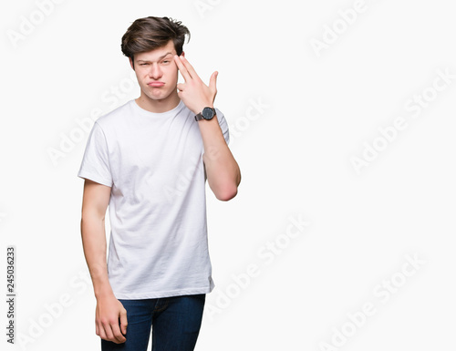 Photography Young handsome man wearing casual white t-shirt over isolated background Shooting and killing oneself pointing hand and fingers to head, suicide gesture