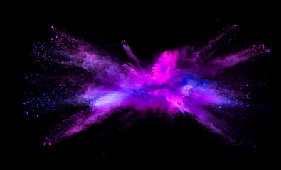 Explosion of colored powder on black background