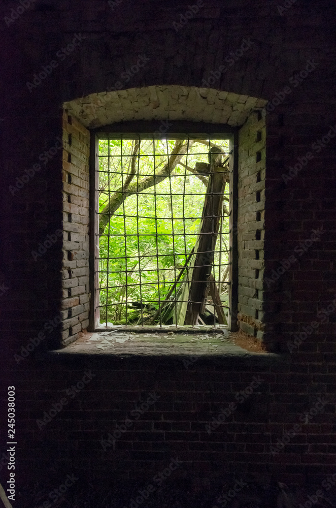 Old window Window and fence. Light outside the window.
